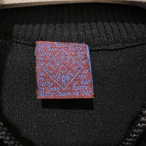 Legate jeans fancy black top with a zipper upfront and open shoulders.